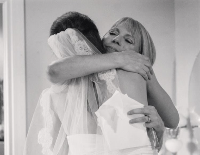 Mom hugs daughter on wedding day