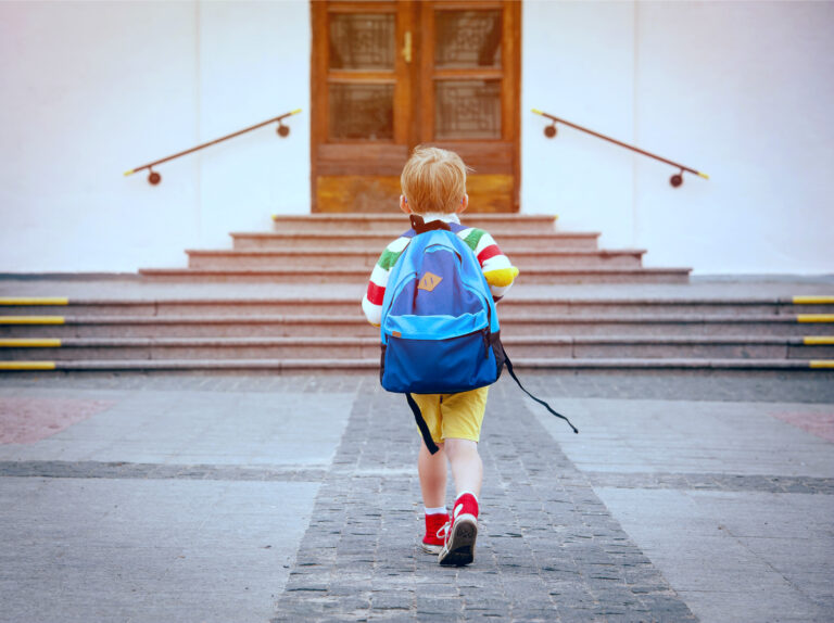Boy running to school steps