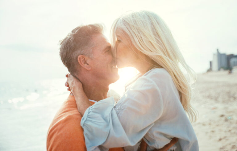 Woman kissing man on beach