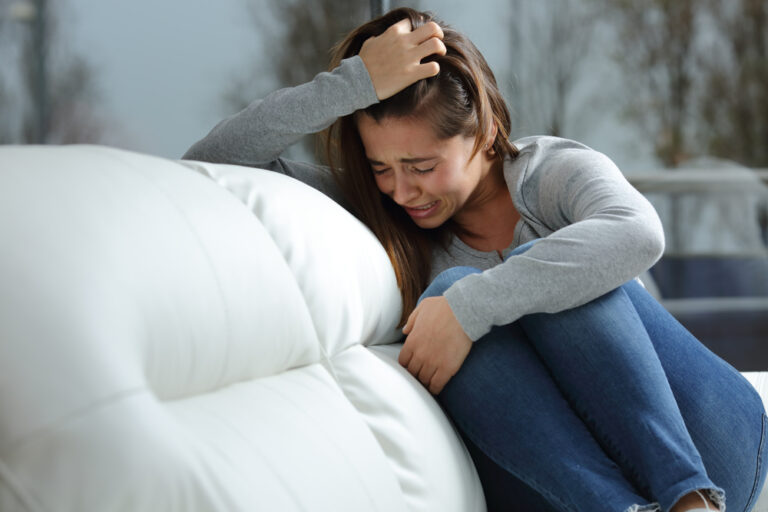 Crying woman on couch