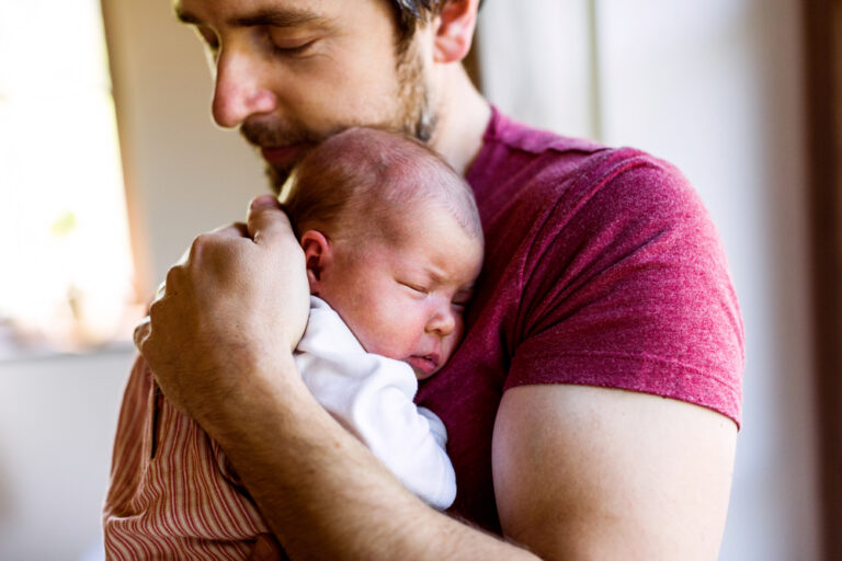 Man holding his newborn baby