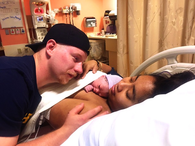 Newborn baby with parents in the hospital