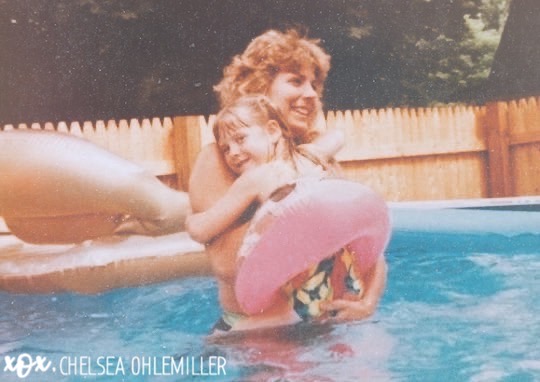 Mother and daughter in swimming pool, color photo