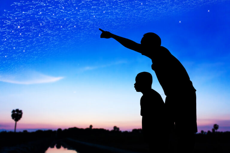 Father and son stargazing