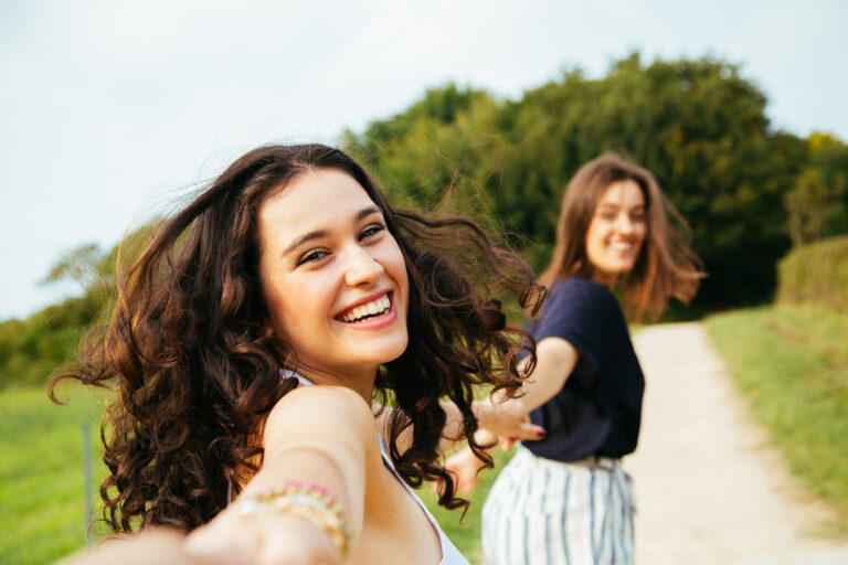 Two girls smiling in sun