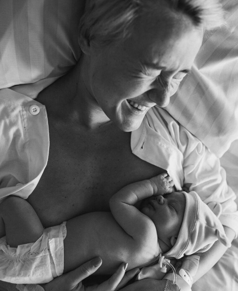 Mother holding newborn, black-and-white photo