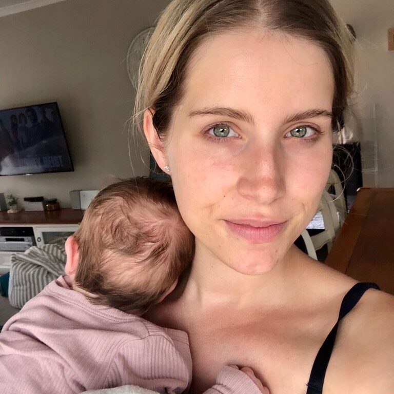 Mother holding newborn selfie, color photo