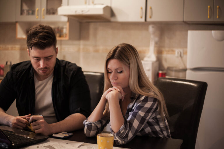 Couple paying bills at table