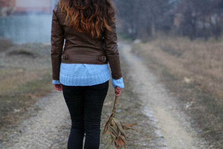 Woman walking down road alone