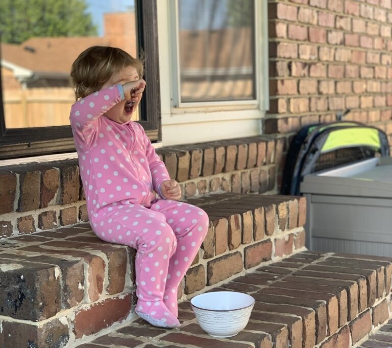 Little girl sitting on steps, color photo