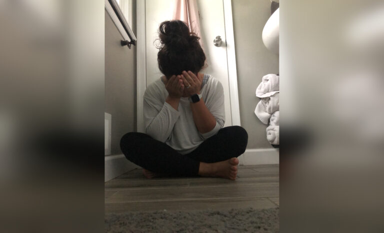 Woman crying on hallway floor