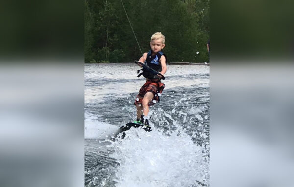 Little boy wakeboarding