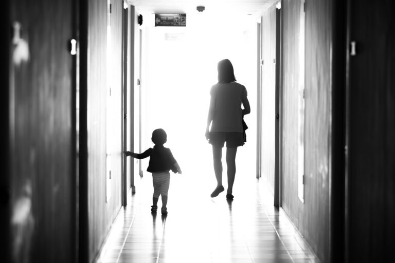 Mother and child walking down hallway