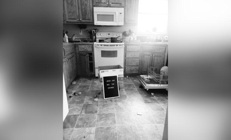 Messy kitchen floor, black-and-white photo
