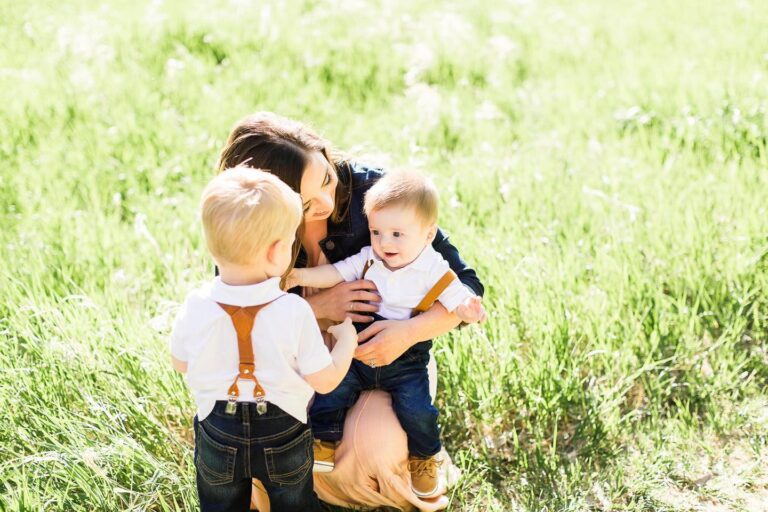 Mother and two sons in a field of grass, color photo