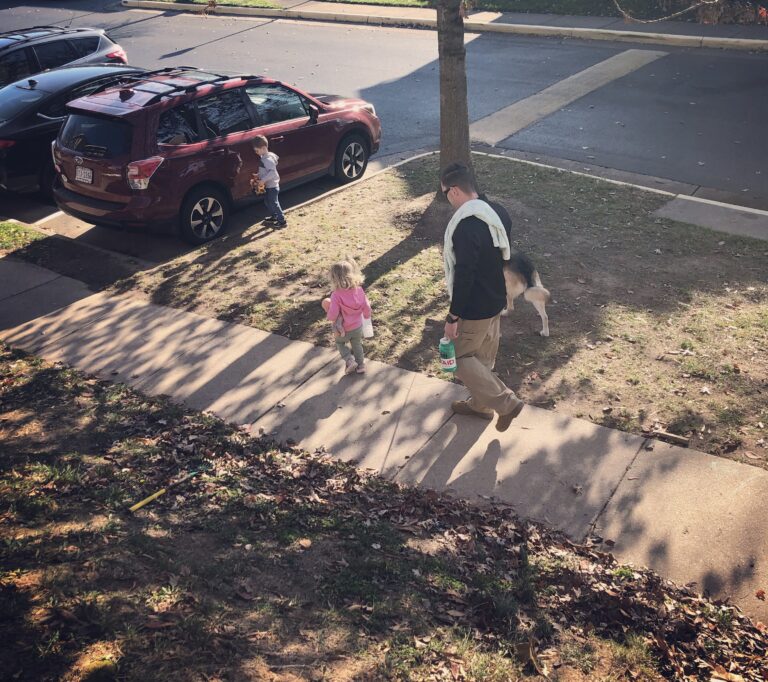Family walking on sidewalk
