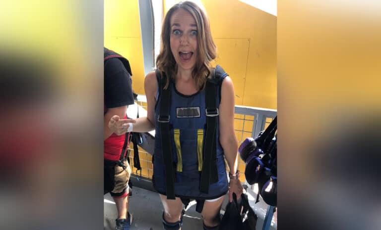 Woman standing with jumping harness, color photo