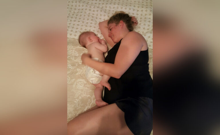 Mother with baby on bed
