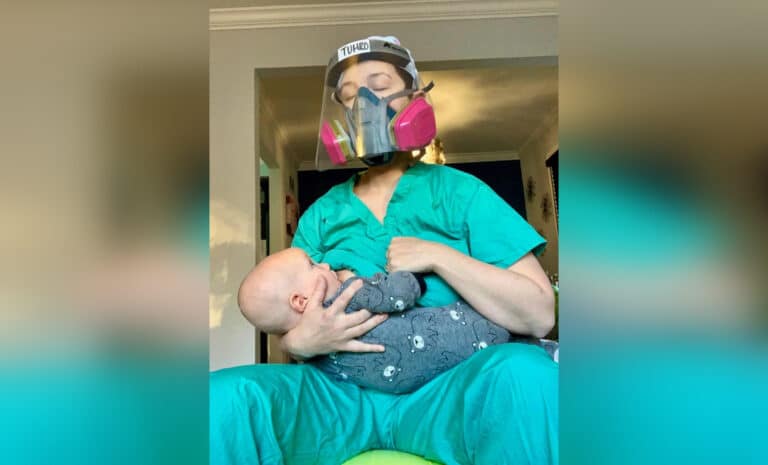 Nurse breastfeeding baby in face mask
