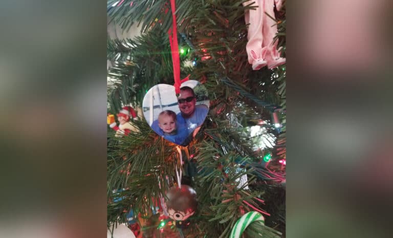 Christmas ornament with picture of man and child, color photo