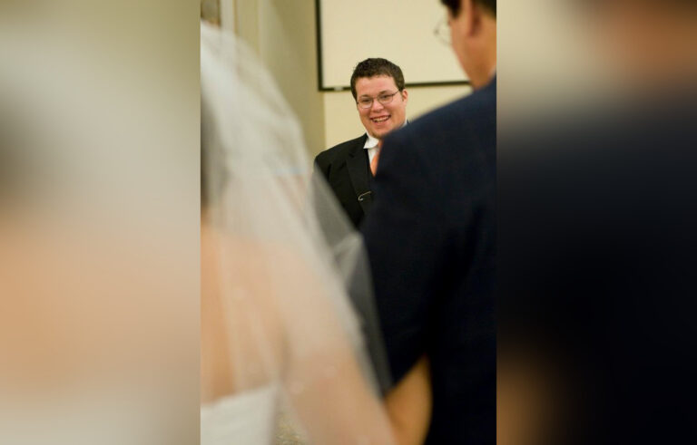 Husband looking at wife on wedding day, color photo