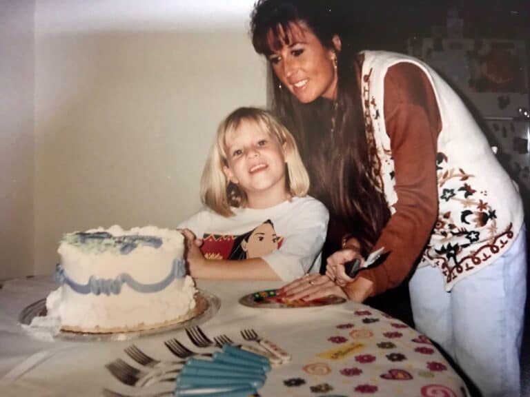 Mother with daughter at birthday party, color photo
