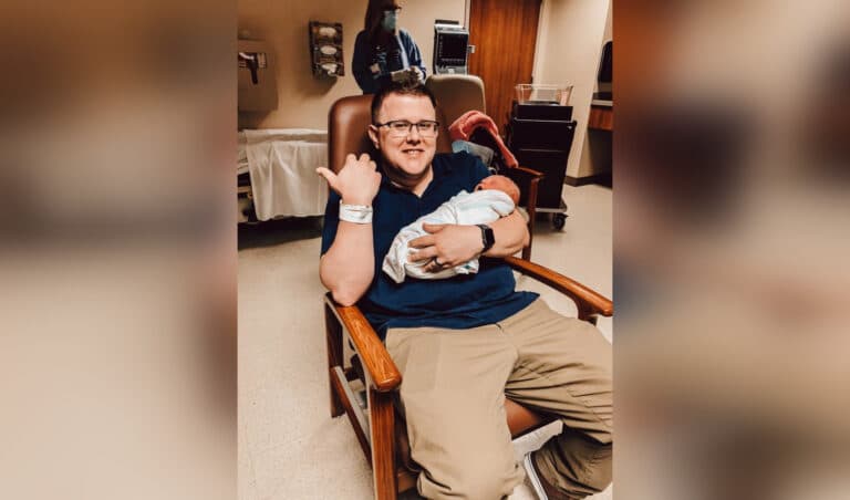 Man holding newborn