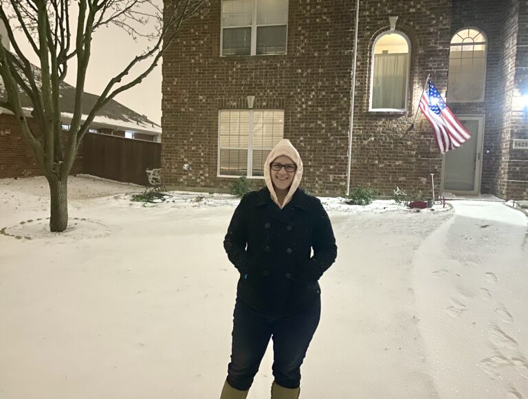winter storm in Texas woman by house