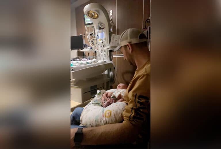 Dad holding baby in NICU