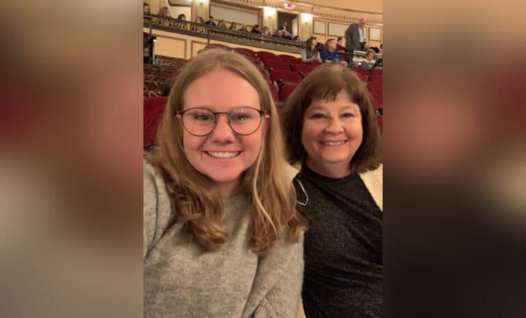 Mother and adult daughter at theater, color photo