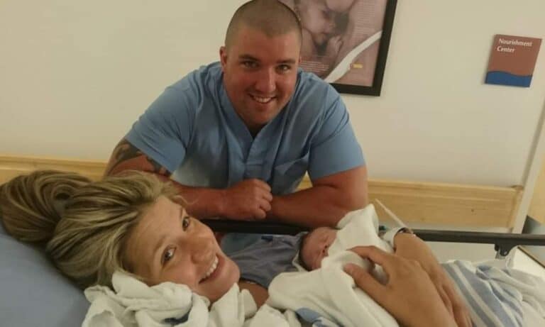 Husband, wife, newborn in hospital, color photo