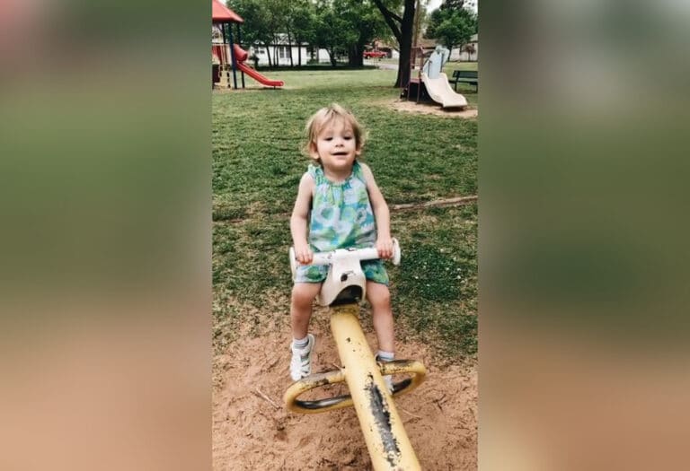Child on see-saw, color photo