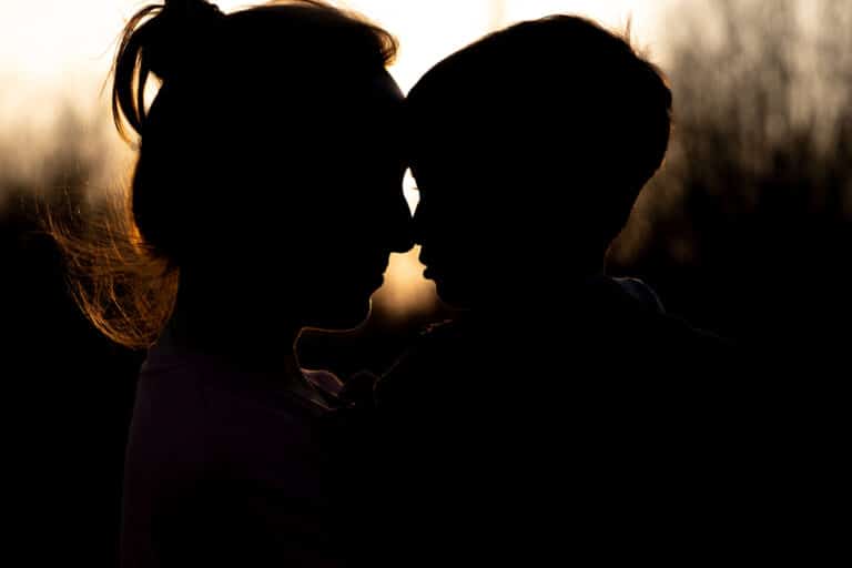 Mom and son touching noses silhouette
