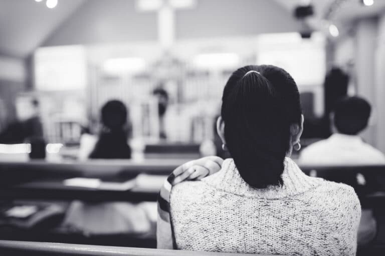 Woman sitting in church pew