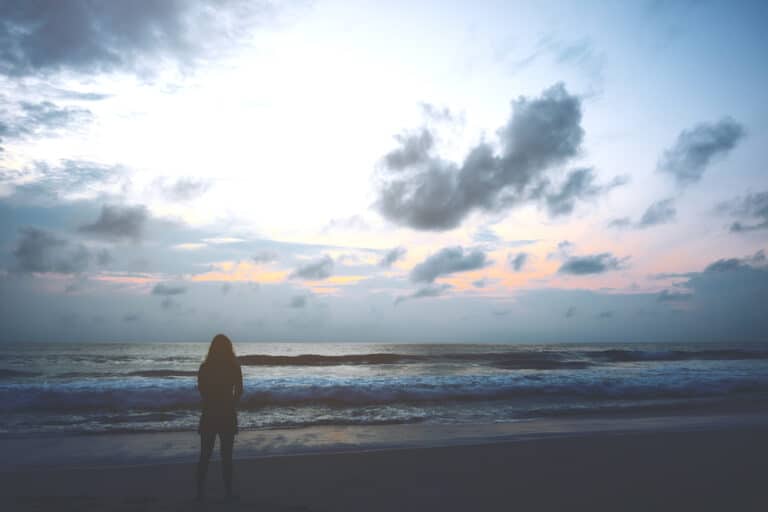 Woman standing by ocean