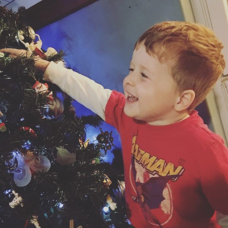 Little boy by Christmas tree
