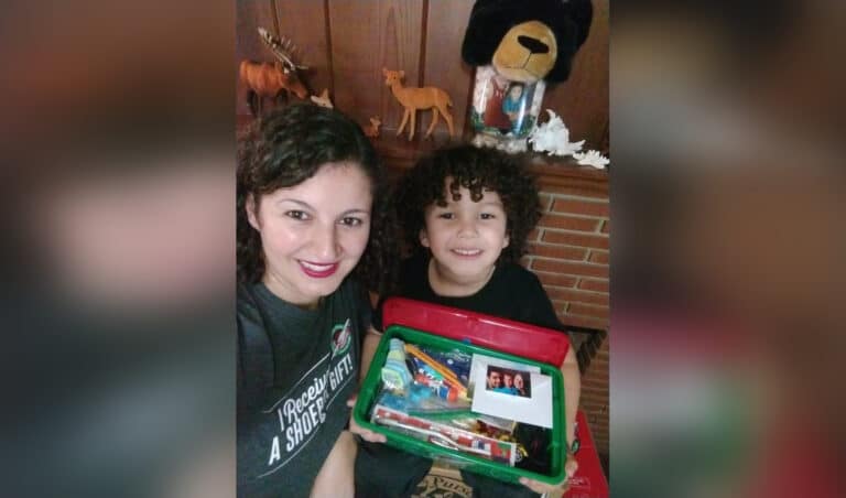 Mother and child with Operation Christmas Child shoebox