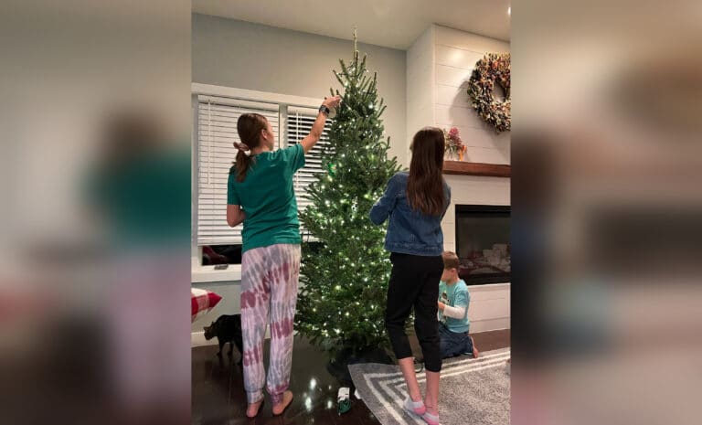 Teens putting up Christmas decorations
