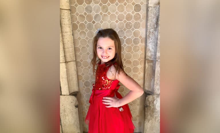 Little girl standing in fancy dress, color photo