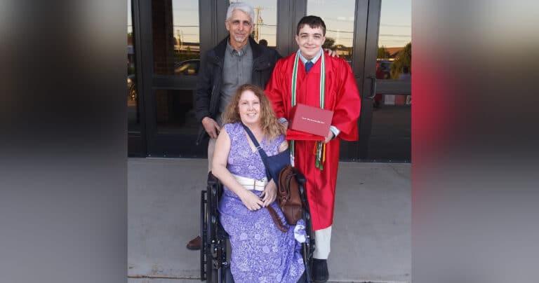 Mother with husband and son in graduation gown, color photo