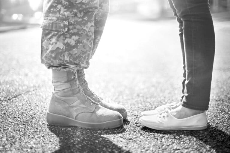 Combat soldier's feet with woman's feet
