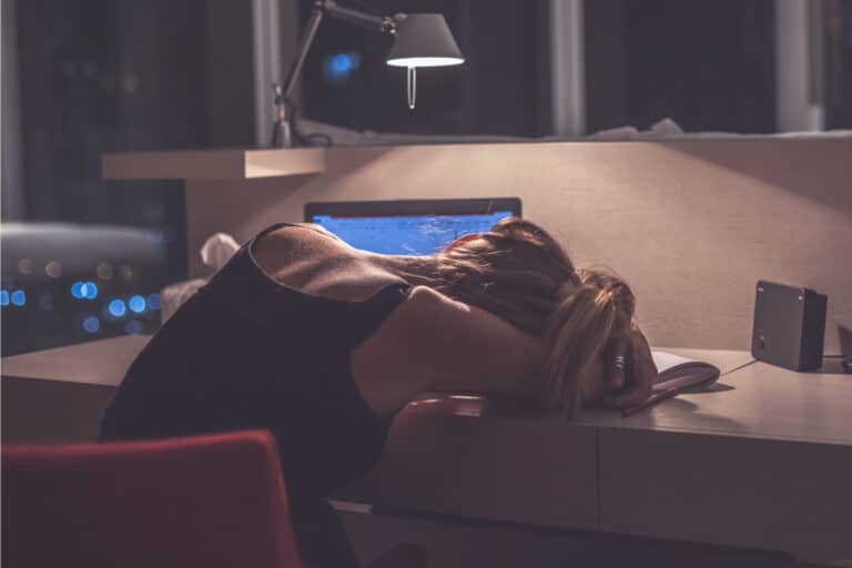 Tired woman head on desk