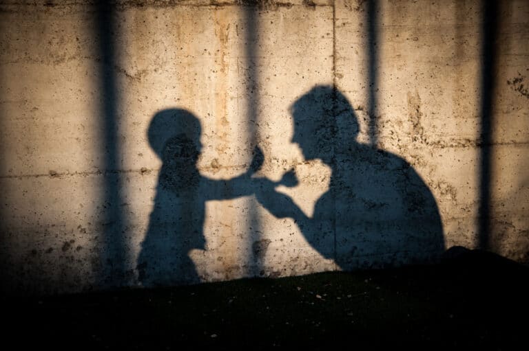 Shadow of boy and mother on wall