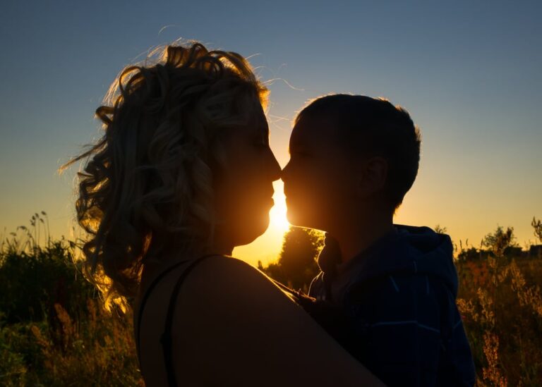 mother and son kiss silhouette
