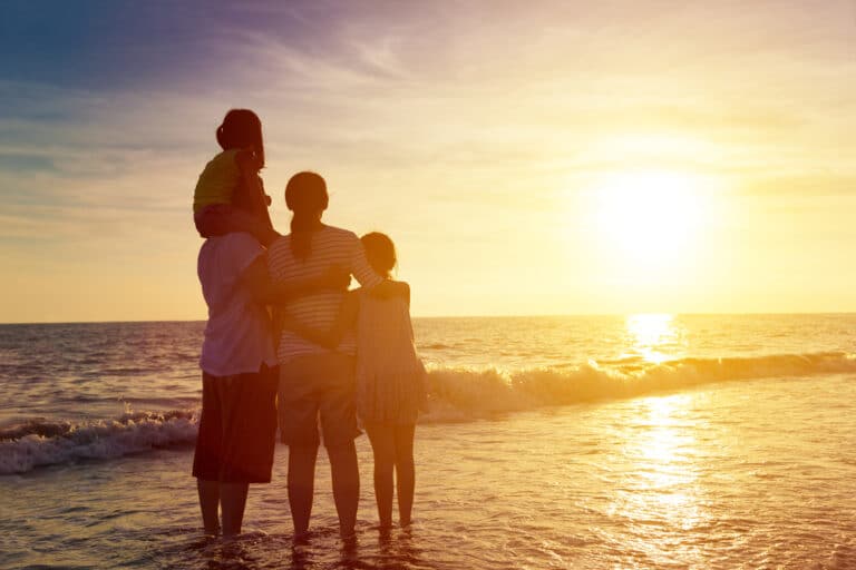 Family watching sunrise at beach