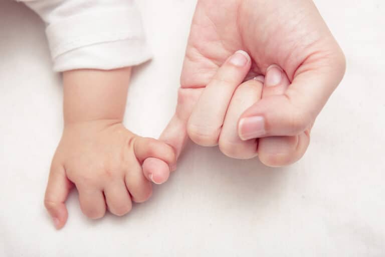 Holding baby hand