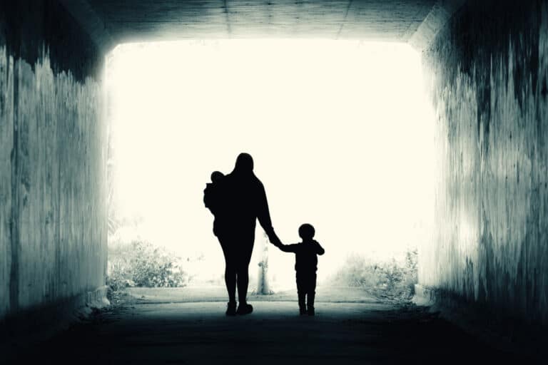 Woman walking in tunnel with kids