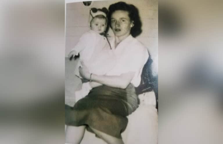 Grandmother holding granddaughter, black-and-white photo