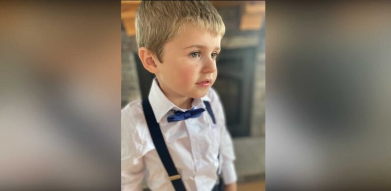 Little boy in suspenders and bow tie, color photo