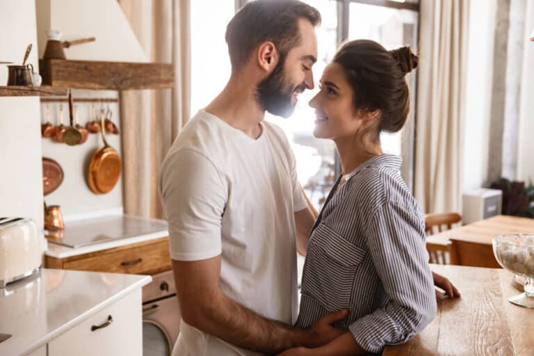 Man and woman smiling at each other in kitchen